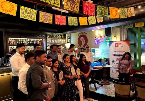 corporate employes are standing with award organized by travelites
